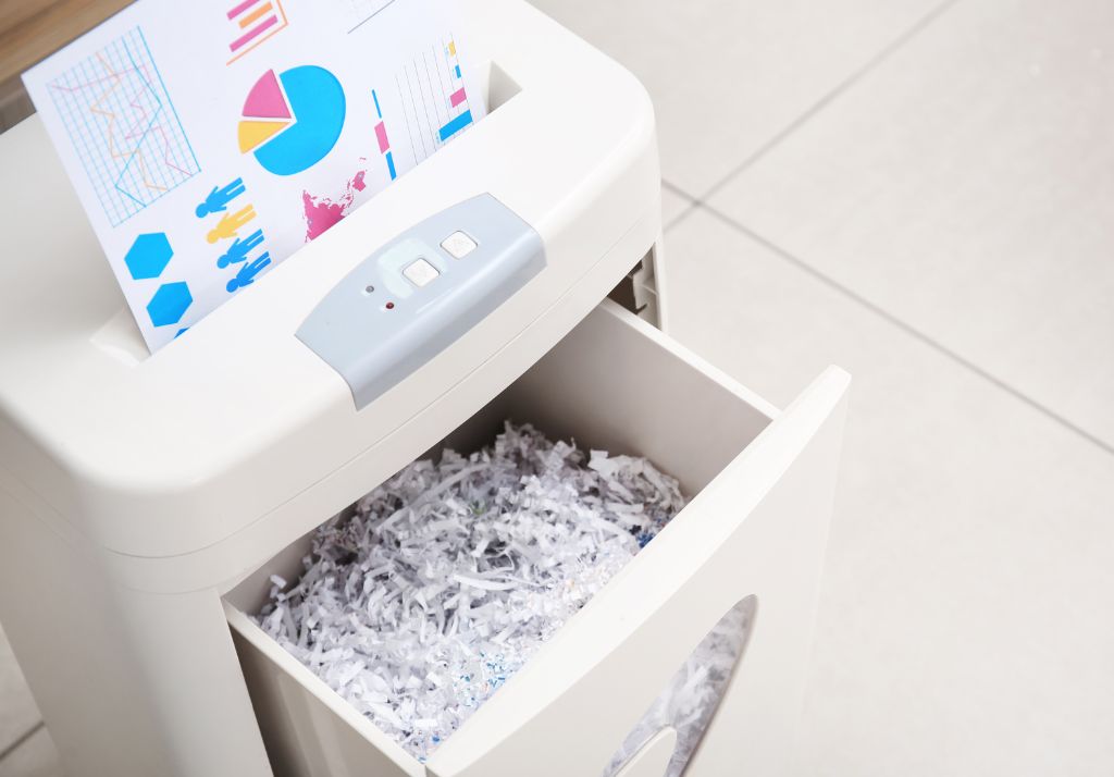Paper shredder destroying data documents