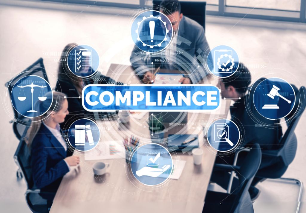 business people around a table with compliance icons