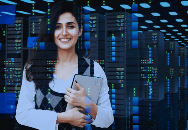 Happy person standing in the server room of a data center 