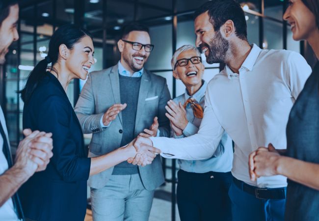 Group of business partners shaking hands in an office 