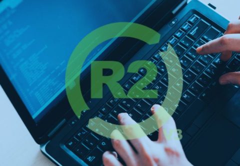 R2v3 logo and man using a laptop